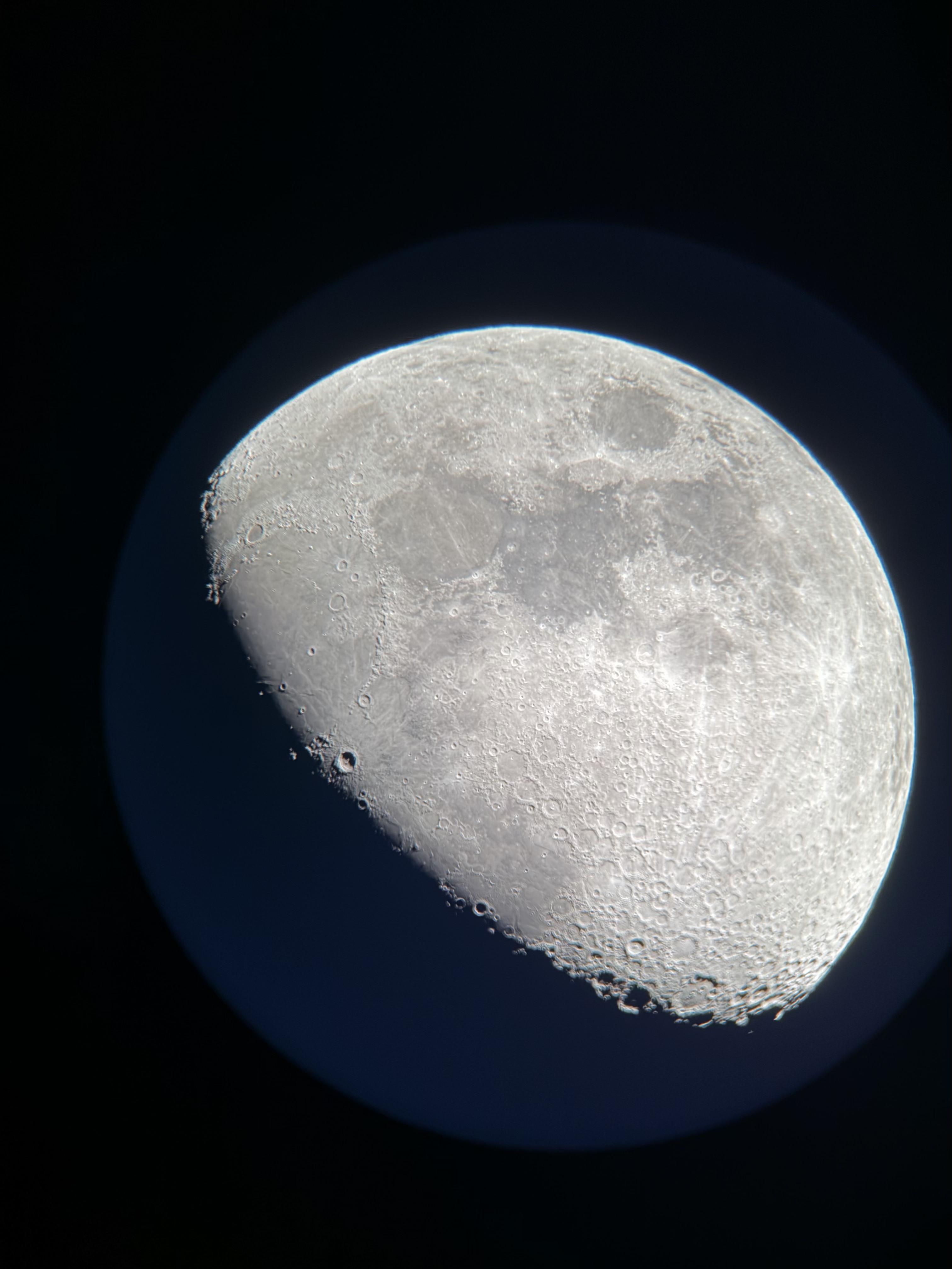 Full-disk waning gibbous moon captured afocally through Celestron NexStar 8SE and iPhone 17 Pro, unprocessed original showing vignetting from NexYZ adapter alignment